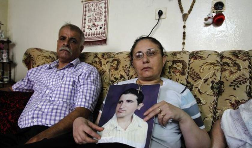 Christian family hold picture of abducted son whom officials said willingly converted to Islam.